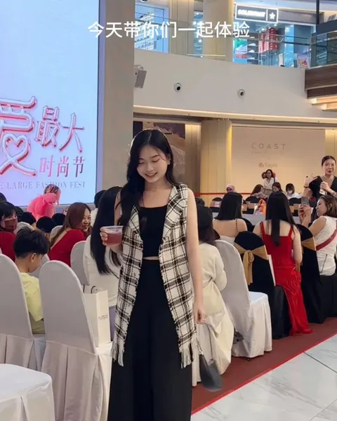 Creator wearing a checked vest at a fashion event